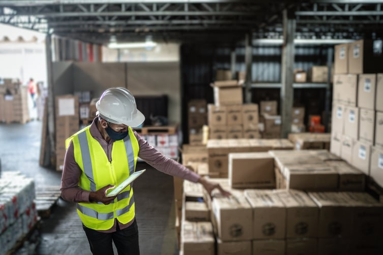 man-in-vest-checking-stock-in-warehouse